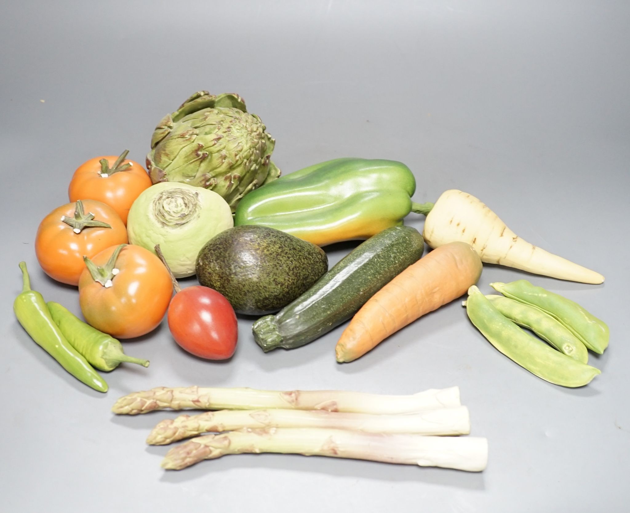 A collection of vintage Penkridge ceramic vegetables including an artichoke, avocado, peppers and asparagus (19 items)